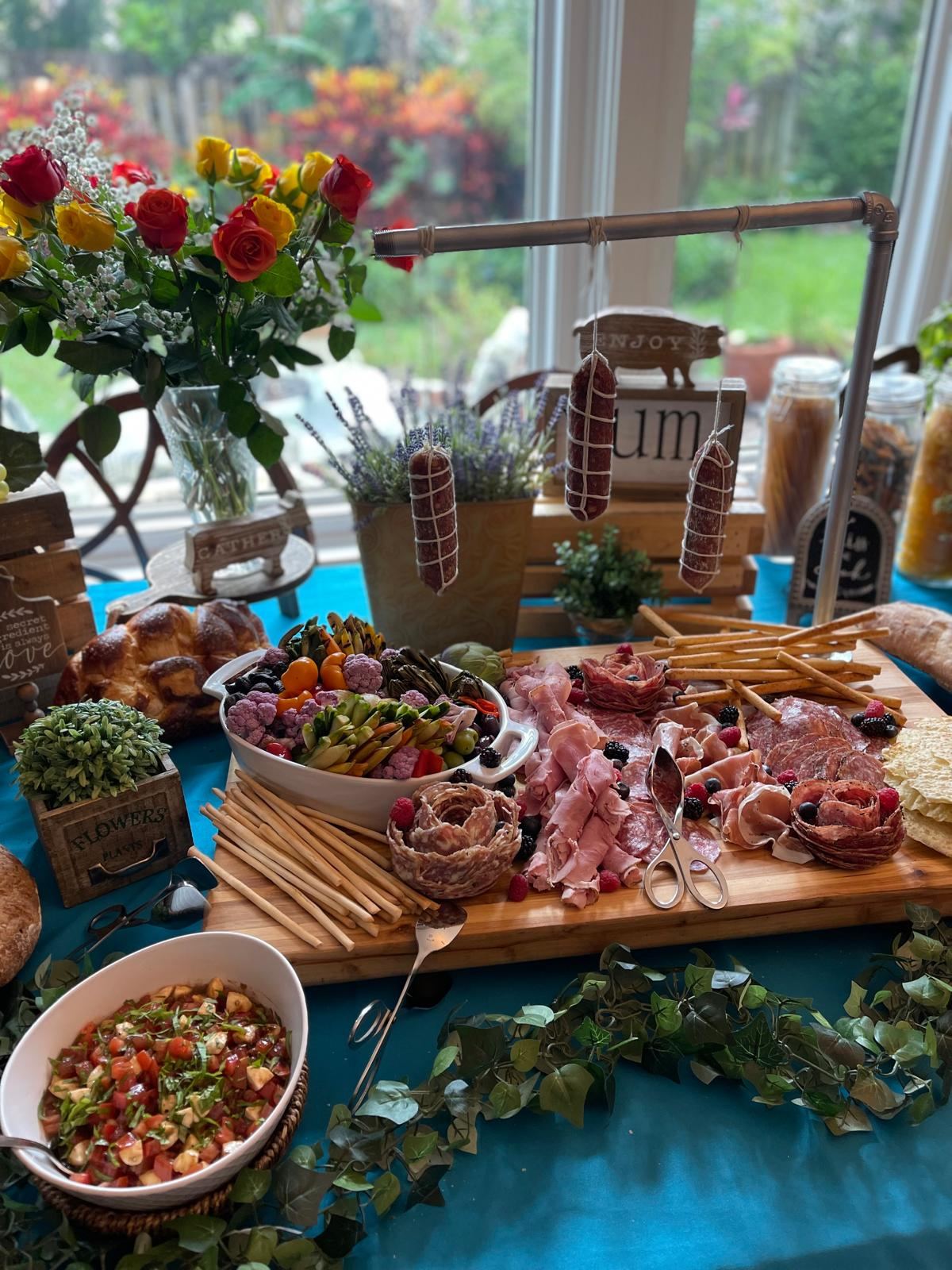 Charcuterie and antipasto display in a home with garden views