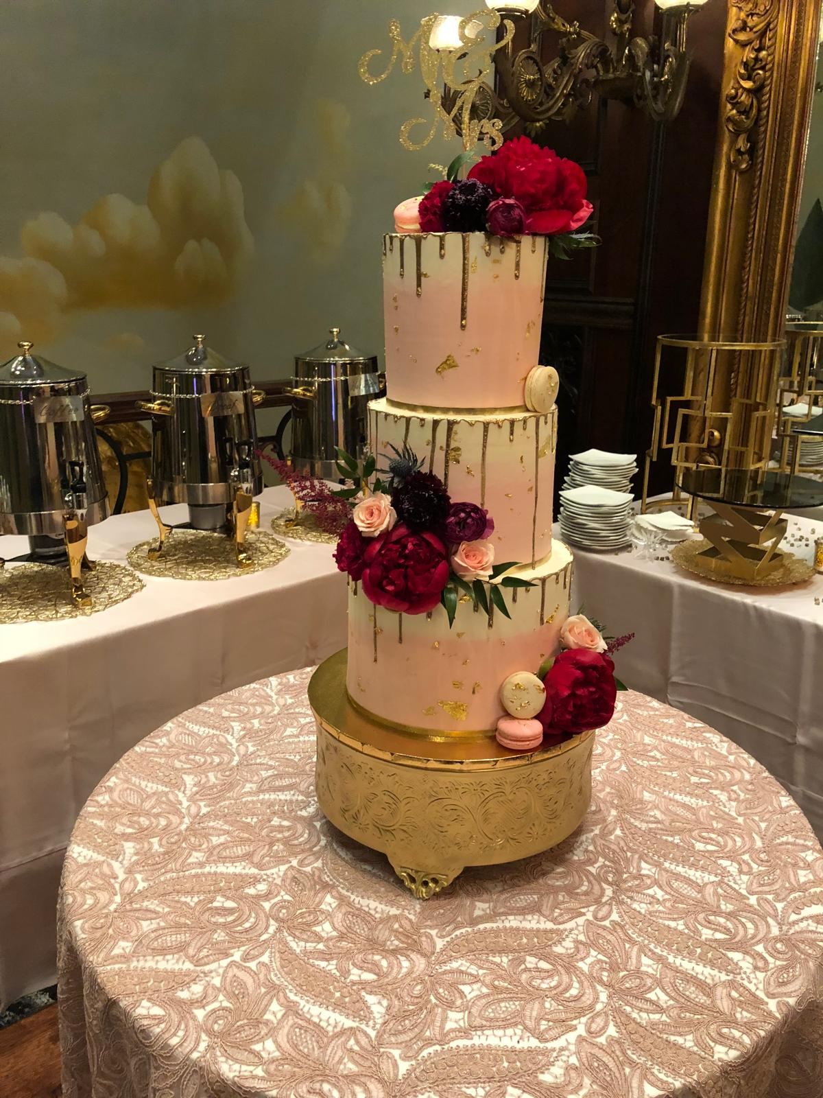 Blush and gold drip wedding cake with peonies